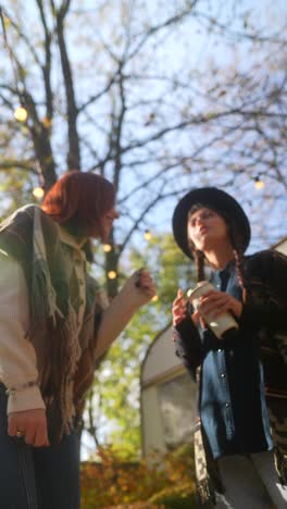 two friends enjoying a conversation in the autumn park