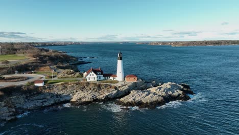 beautiful historical light house at the gray rocks in the casco bay on a bright sunny day