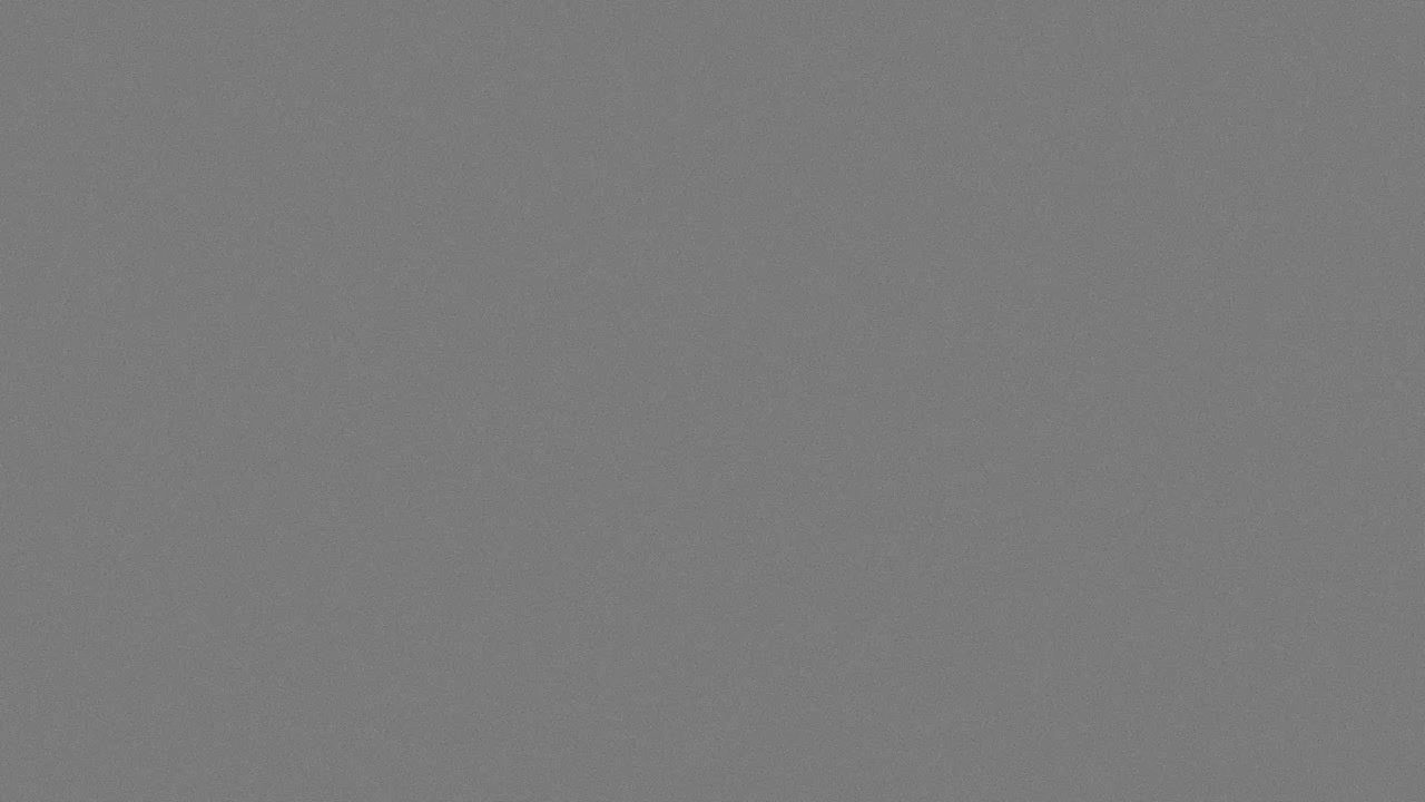 35mm film grain texture overlay with subtle noise on gray background, seamless loop
