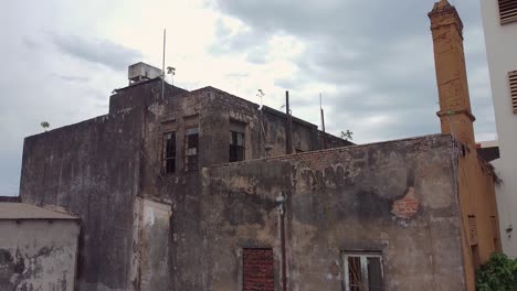 Slow-rising-and-tilting-drone-shot-revealing-the-run-down-Savoy-Hotel-in-Posadas