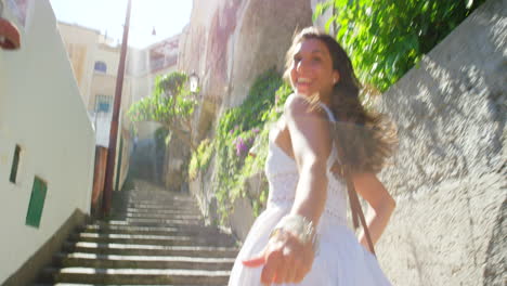 carefree cheerful young woman running up stairs