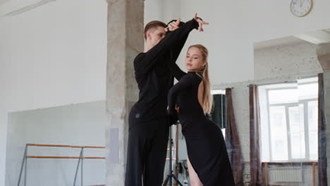 Professional Ballroom Dancers Practicing in a Studio
