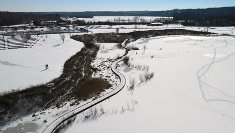 Flying-fast-over-a-frozen-fishing-pond-in-winter-at-Liberty-Park-in-Clarksville,-Tennessee