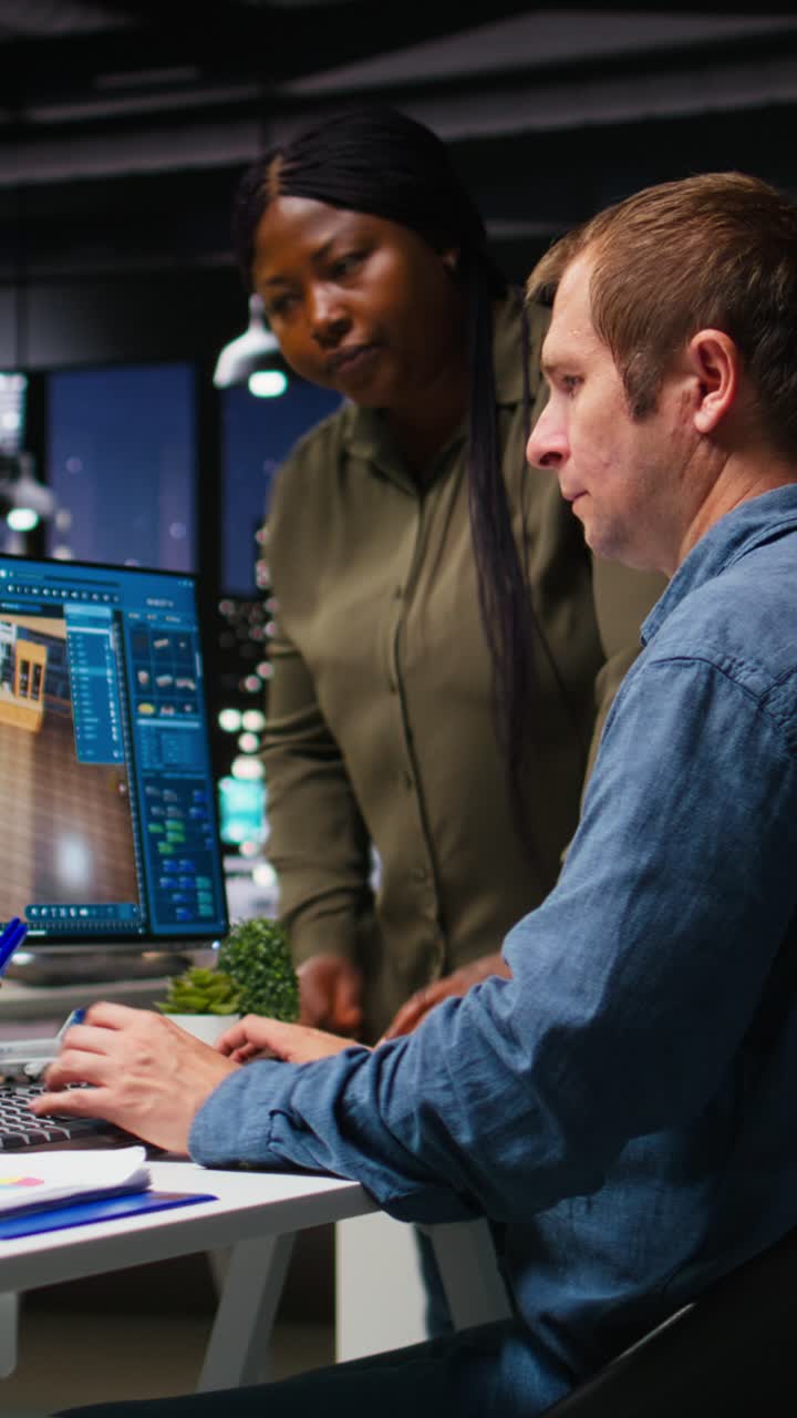 Vertical Video Diverse engineering team designing a floor plan on dual monitors