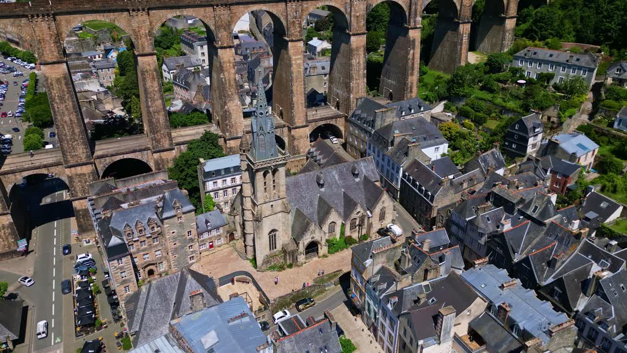 Beautiful panoramic drone movement around the gothic style Saint-Melaine Church in Morlaix, Brittany, France.