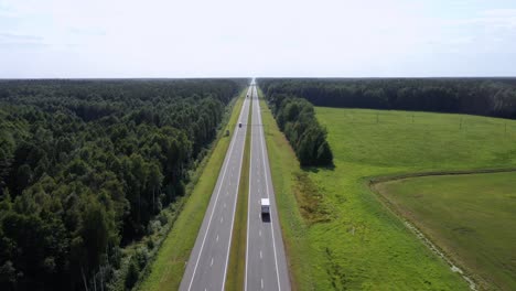 trucks driver with trailer carrying cargo on speed intercity highway aerial view