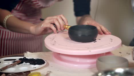 pottery workshop: painting a bowl