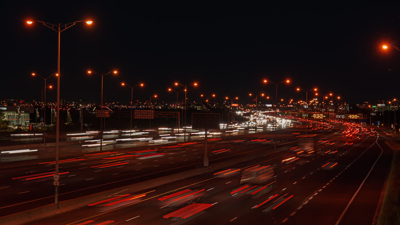 Nighttime timelapse of busy Hwy 401 in Ontario, Canada with bright lights