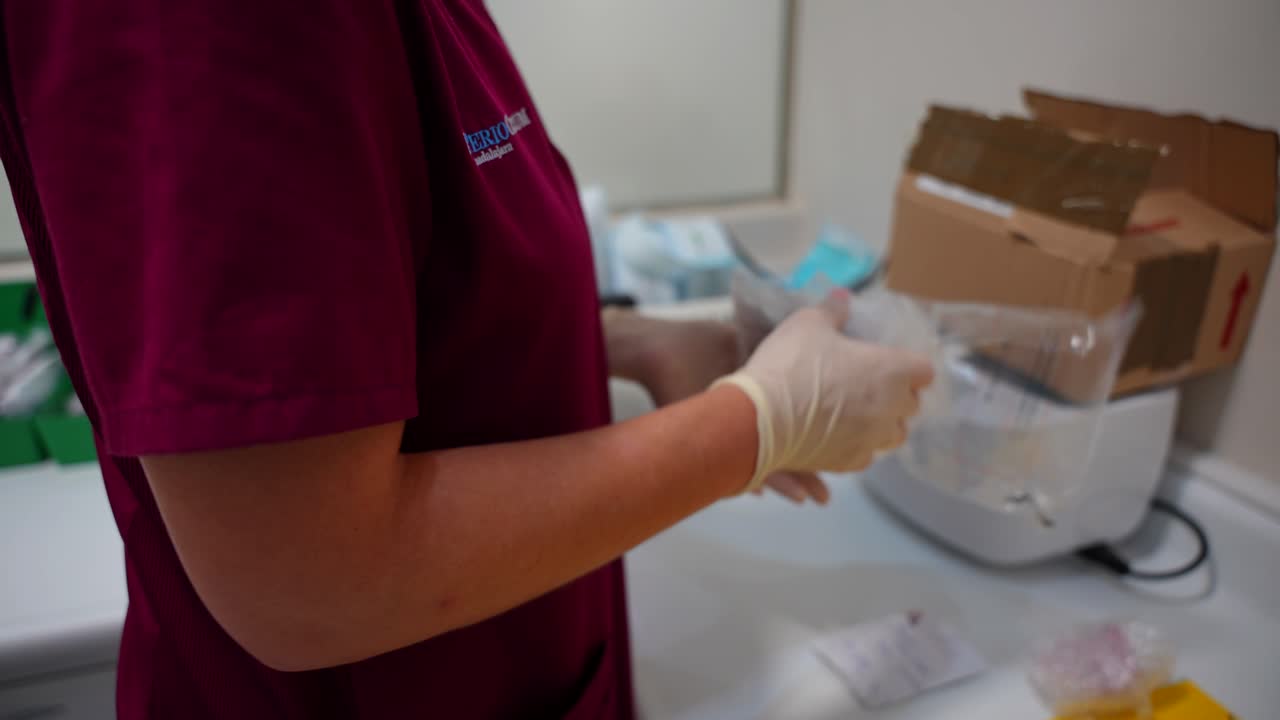 Person in a lab preparing medical packages.