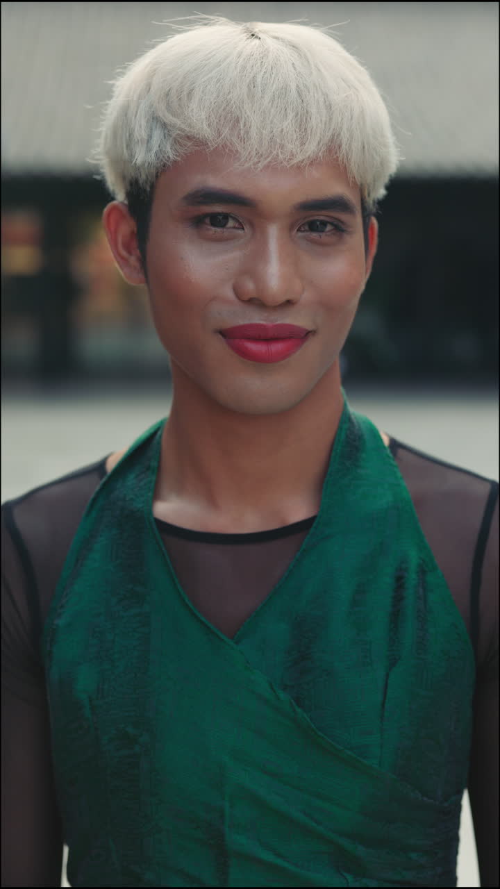 Portrait of a person with white hair and green dress