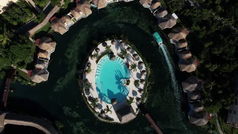 Birds-Eye-Aerial-View-of-Pool,-Tropical-Sea-Lagoon-and-Resort-Bungalows,-Mexico