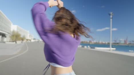 young woman dancing in a city port