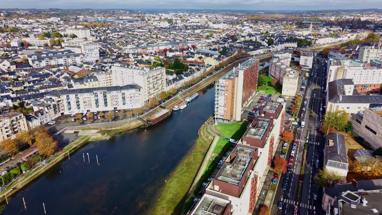 Le Mans cityscape, France in autumn, Sarthe river, autumn colors. Aerial drone forward