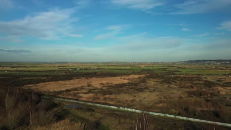 Aerial-:Flying-backwards-over-bare-tree-tops