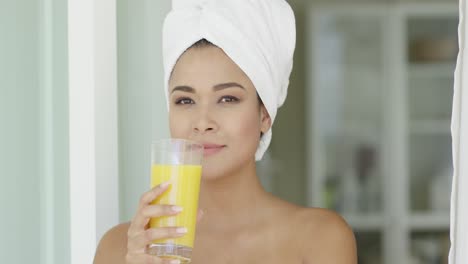 smiling healthy young woman drinking orange juice
