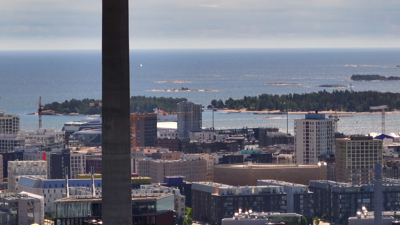 Telephoto drone shot circling the Jatkasaari district, in sunny Helsinki, Finland