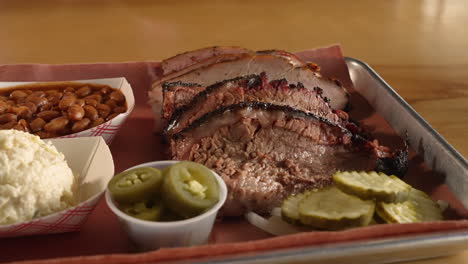 Smoked-turkey-and-moist-brisket-fill-tray-of-traditional-Texas-barbecue-two-meat-plate,-slider-close-up-4K