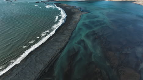 aerial view tilting over the fjorur beach, toward the vestrahorn peak in iceland
