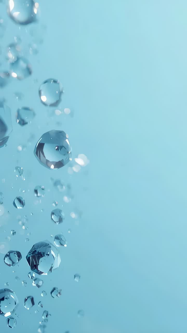 Video verticale: goccioline trasparenti che salgono sul lato sinistro spinte dalla forza di galleggiamento su uno sfondo blu chiaro, con spazio per il testo