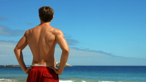 Fit-man-stretching-on-the-beach