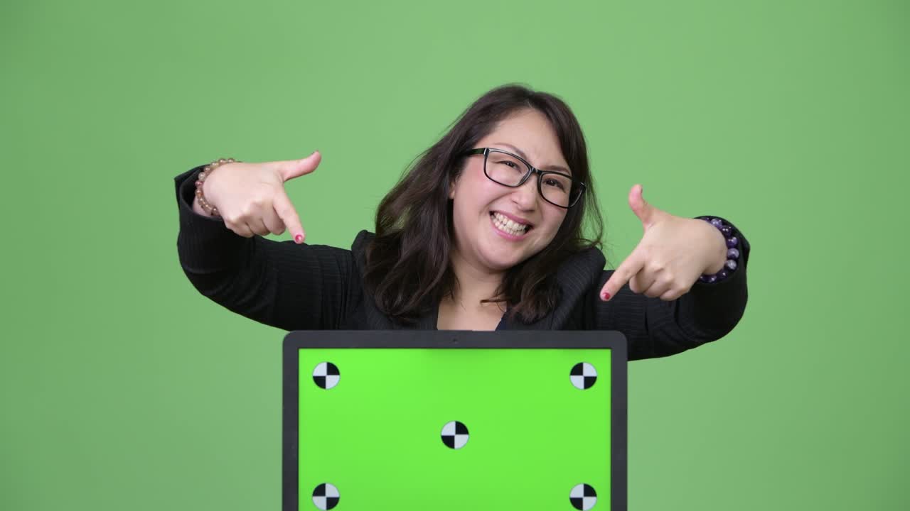 una hermosa mujer de negocios asiática madura mostrando su computadora portátil