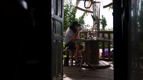 man enjoys his coffee in the morning in the company of his cat in a beautiful cabin in the woods