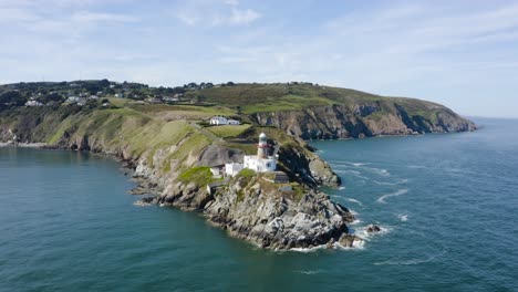 flying around the baily lighthouse at howth head during a sunny day