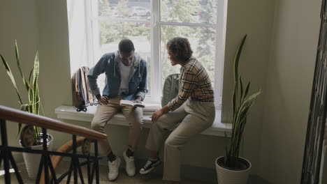students studying together at window seat