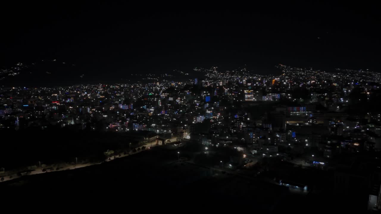 Beautiful drone footage of Kathmandu city at night during Diwali (Tihar), glowing with colorful lights, diyas, and decorations that reflect Nepal’s vibrant culture, joy, and festive celebration