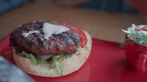 hands placing and holding a delicious burger