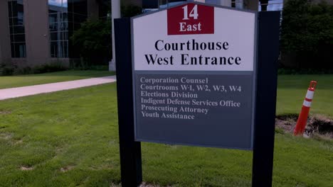 Oakland-County-Courthouse-West-Entrance-sign-in-Michigan-with-gimbal-video-tilting-up