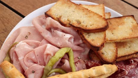 antipasto platter with meats, bread, and olives