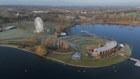 An-aerial,-early-morning-view-of-Willen-Lake-in-Milton-Keynes,-showing-the-waterfront-and-Observation-Wheel