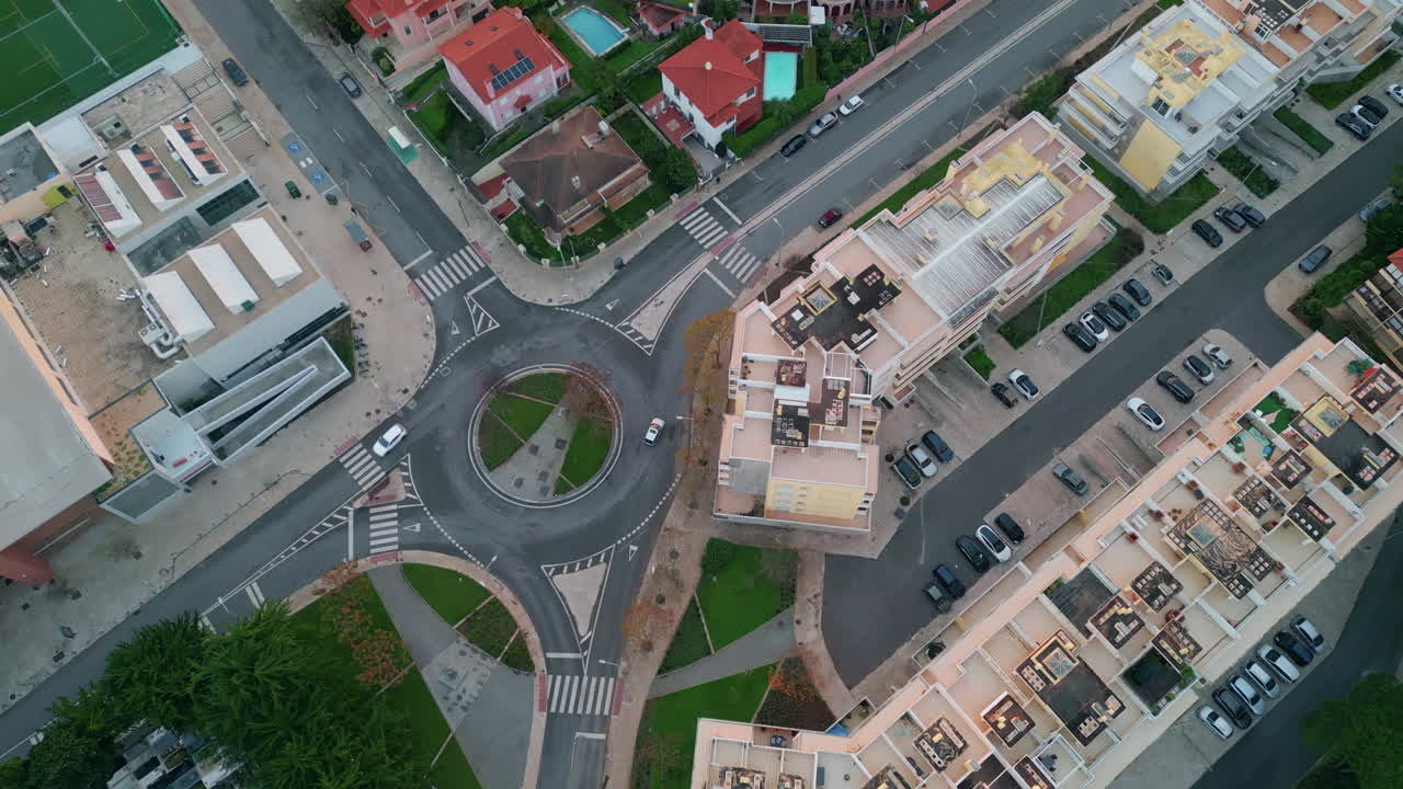Aerial city intersection roads and roundabout. Urban area with buildings traffic