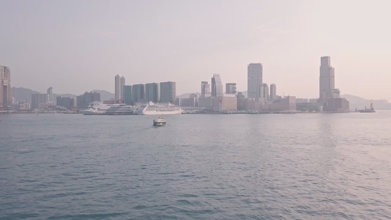 Hong Kong star ferry heading towards Kowloon. Aerial drone view