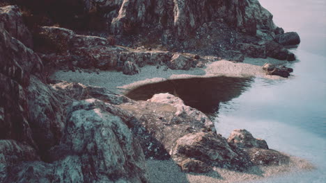 Acantilados-De-Playa-Y-Piedra-Caliza-Contra-El-Agua-Azul