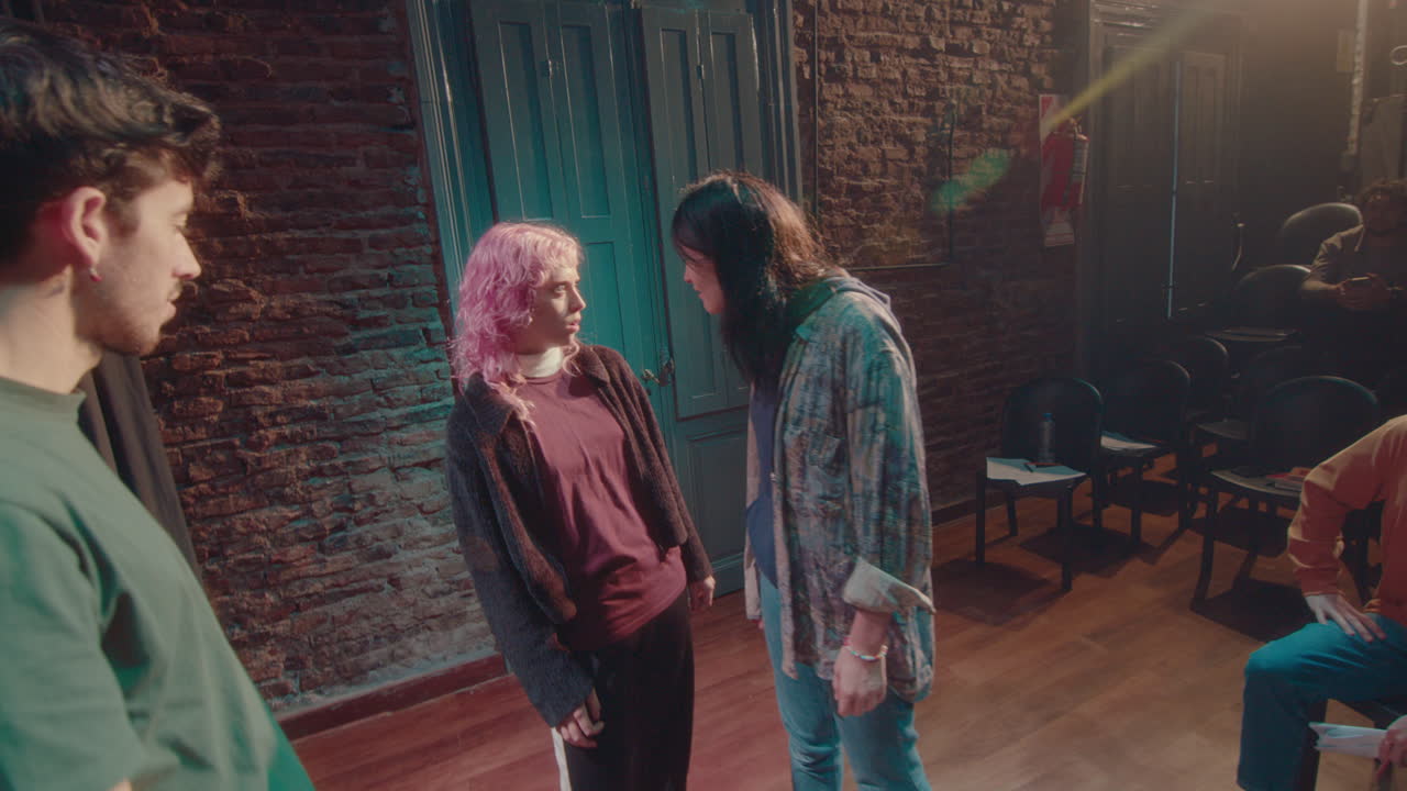 Theater Director Explaining Young Performers How to Act on Stage