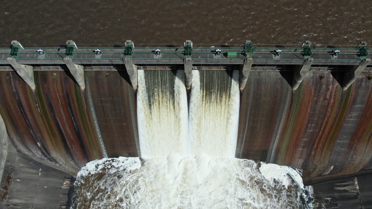 Rising up and looking down aerial footage of water being released from Lauriston Reservoir, in central Victoria. October 2022.
