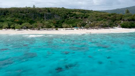 drone footage of crystal clear blue water and waves on the shore of beach in cebu philippines-14