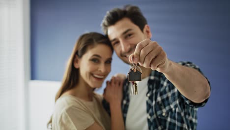 portrait video of couple showing a bunch of home keys.