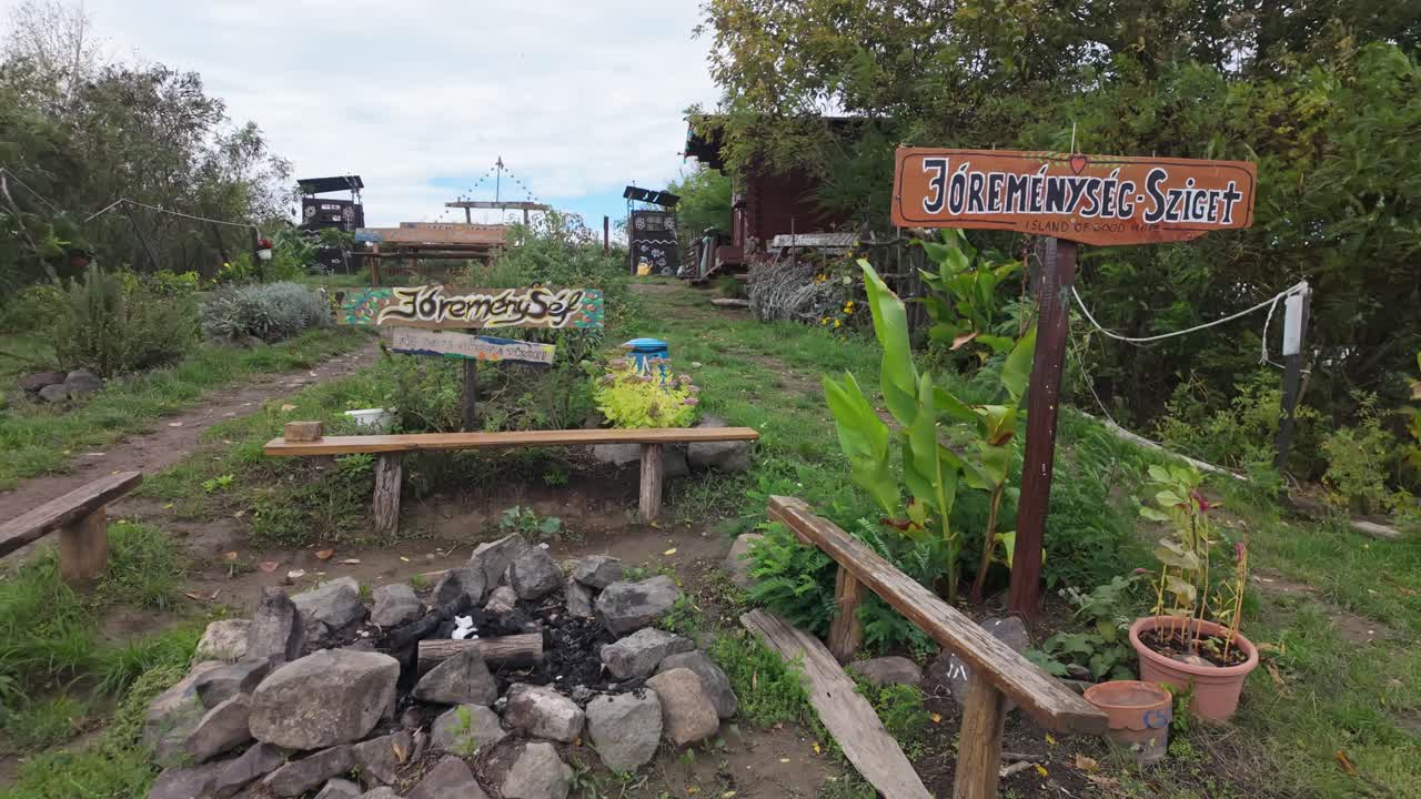 Cozy community garden with an outdoor fireplace at the Jóreménység-sziget community place in Abádszalók, Hungary