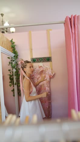 woman in dressing room trying on clothes