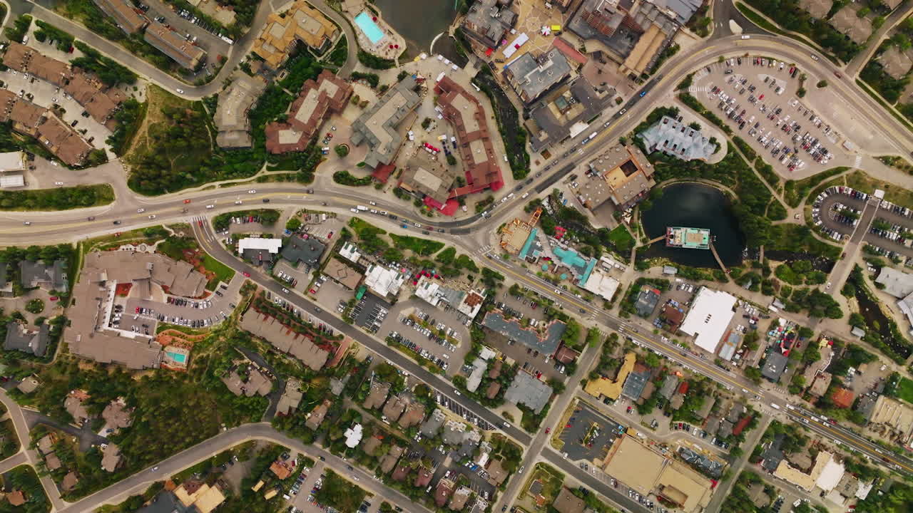 Densely built little town of American state of Colorado. Aerial view of the busy streets of resort town in summer season.