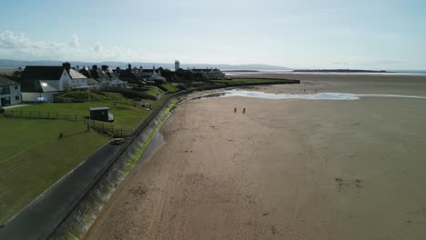 Hoylake-Beachfront-conservation-area---aerial-drone-flyover-towards-Hilbre-Island,-Wirral,-UK