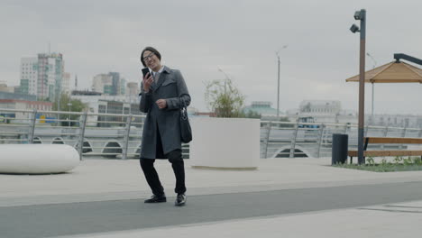 happy businessman dancing in the city