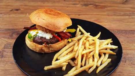 close up of a lamb burger with french fries gently squashed showing how fluffy the bun is