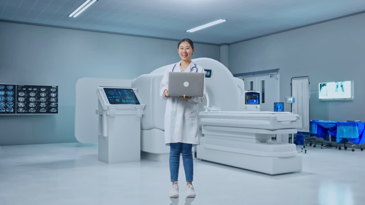 Full Body Of Asian Woman Doctor With Stethoscope Holding A Laptop And Smiling With Mri Machine In The Hospital
