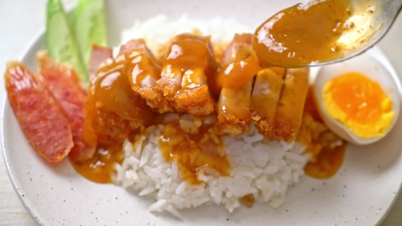 crispy belly pork on rice with barbecue red sauce
