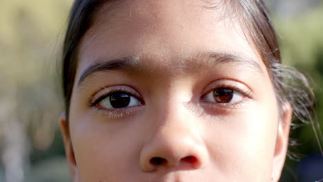 close-up of child's face with focused eyes, outdoors in natural light