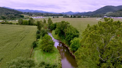 aerial pullout over farm, river and barn near mountain city tennessee